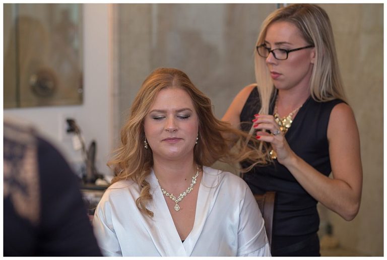 Bride getting her hair done before her wedding.